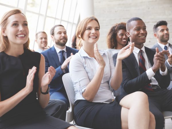 Audience Applauding Speaker At Business Conference